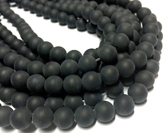 May include: A strand of black matte round beads. The beads are uniform in size and have a smooth, polished finish.