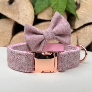 May include: A pink and white tweed dog collar with a rose gold buckle and matching bow tie.