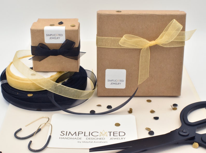 Simplicated Jewelry items arrive in a box tied with a bow, ready to keep or gift.