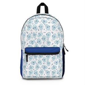 May include: A blue and white backpack with a repeating pattern of cartoon characters. The characters include Mickey Mouse, Donald Duck, Goofy, Pluto, and Daisy Duck. The backpack has a blue zippered pocket on the front.