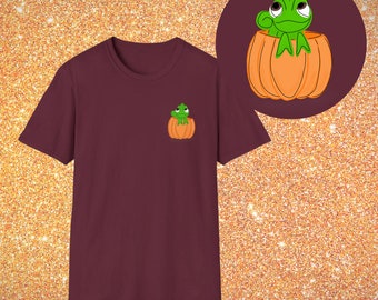 May include: A maroon t-shirt with a green chameleon sitting inside a small orange pumpkin on the left chest of the shirt.