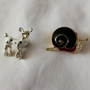 Two enamel Brooches. A deer and a snail.