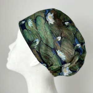 May include: A green, blue, and white patterned surgical scrub hat with a floral design. The hat is made of a soft, comfortable fabric and is perfect for nurses, doctors, and other healthcare professionals.