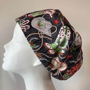 May include: A black scrub hat with a Christmas cowboy theme. The hat features a repeating pattern of cowboy boots, hats, and rope with a Christmas tree and candy cane accents.
