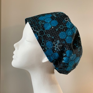 May include: A black and blue scrub hat with a geometric pattern of hexagons and chemical formulas. The text "Ag 96" is visible on the hat.