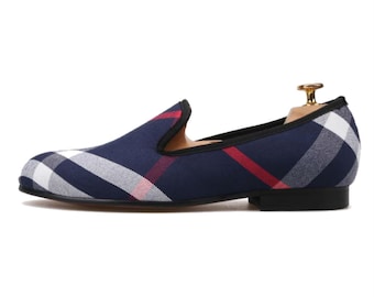 May include: Navy blue plaid slip-on loafers with a red and white plaid pattern.