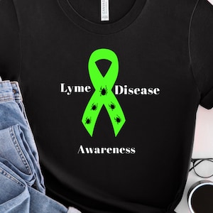 May include: Black t-shirt with a green ribbon and the text "Lyme Disease Awareness" with black tick silhouettes on the ribbon.