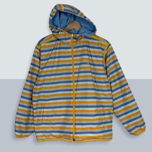 May include: A blue and yellow striped hooded jacket with a zipper closure. The jacket has a small logo on the left chest.