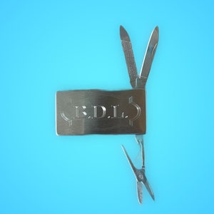 May include: A silver multi-tool with a knife, scissors, and a nail file. The tool has the initials "E.D.I." engraved on the handle.