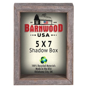 May include: A rustic wood shadow box frame with a white background and the text "BARNWOOD USA 5X7 Shadow Box 100% Recycled Materials Made in the USA Oklahoma City, OK".