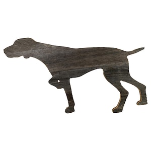 May include: A wooden silhouette of a dog in a standing position. The silhouette is made of reclaimed wood with a dark brown color.