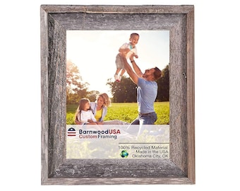 May include: A rustic wood picture frame with a gray weathered finish. The frame is made from 100% recycled material and is made in the USA. The frame is labeled "BarnwoodUSA Custom Framing" and "Oklahoma City, OK".