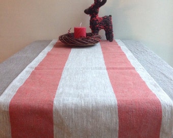May include: A red and white striped linen table runner with a small reindeer figurine and a red candle in the center.