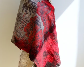 May include: A red and beige wool scarf with a tree and flower pattern. The scarf is draped over a mannequin.