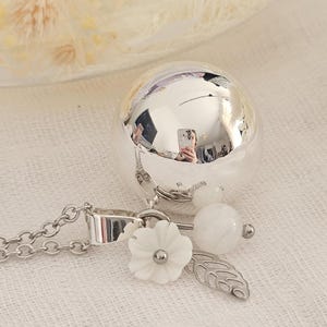 Silver pregnancy bola with mother-of-pearl flower, leaf and moonstone on steel chain