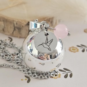 Smooth silver hummingbird and rose quartz pregnancy bola on steel chain