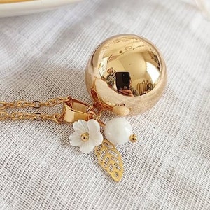 Pregnancy bola gold spring flower leaf and moonstone on gold chain.