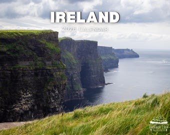 May include: A 2026 calendar featuring a scenic view of the Irish coastline. The image shows dramatic cliffs with green vegetation, overlooking the ocean under a cloudy sky. The word "IRELAND" is at the top.