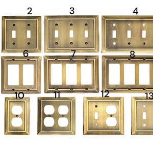 May include: A set of 13 antique brass wall plates for light switches and electrical outlets. The plates are numbered 1 through 13 and feature different configurations of switches and outlets.