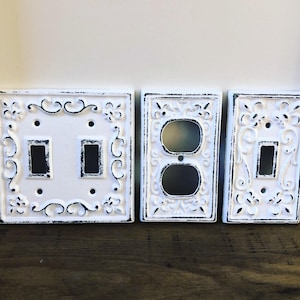 Cubierta de interruptor de luz de flor de lis de hierro fundido envejecido