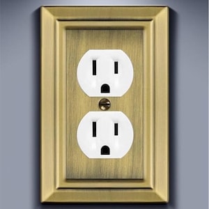 May include: A brass wall plate with a white double electrical outlet.