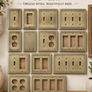 May include: A collection of antique brass switch and outlet covers featuring a beaded border design. The set includes various configurations for single, double, triple, and quadruple switches and outlets, all crafted from solid metal with matching screws.
