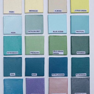 May include: A color chart with 16 paint swatches, each labeled with a color name. The colors include ivory, meringue, almond, citrus green, aqua, catalina mist, blue ocean, nautical, satin beach, pistachio, wild grass green, seaweed, teal, surf, satin lagoon, bluegrass, island splash, lavender, pink champagne, and smoke gray.