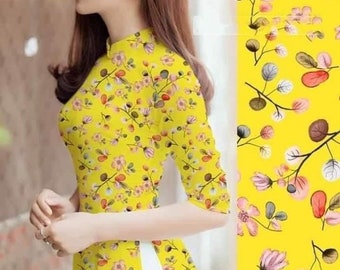 May include: A yellow dress with a floral print. The dress has a mandarin collar and three-quarter sleeves. The dress is made of a lightweight fabric and is perfect for warm weather.