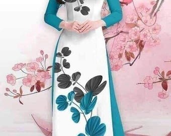 May include: A white dress with a blue and black floral pattern. The dress has a long sleeve and a high neckline. The dress is on a pink background with a floral design.