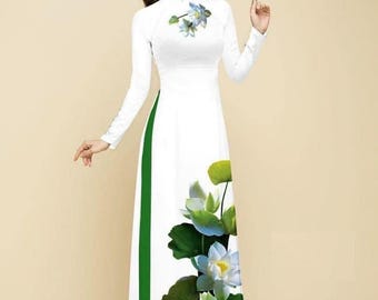 May include: A white long-sleeved dress with a green side panel and a floral print of white lotus flowers. The dress has a mandarin collar and a fitted bodice. The dress is labeled with the number 2401HT.