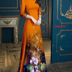 May include: A long orange dress with a floral print on the bottom half. The dress has a round neckline and three-quarter sleeves. The dress is shown on a model against a blue background.