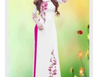 May include: A white dress with pink floral embroidery and a pink side panel. The dress is long and has a fitted bodice and a flowing skirt.