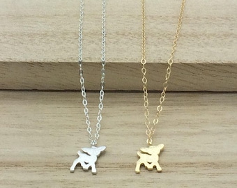 May include: Two delicate necklaces with a small deer pendant. One necklace is silver and the other is gold.