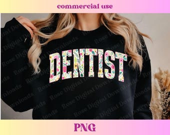 May include: Black sweatshirt with the word "DENTIST" in large, floral-filled letters. The letters are white with a pattern of pink, yellow, and green flowers and leaves. The image also includes the text "commercial use" and "PNG".