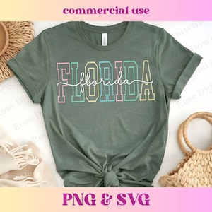 May include: A sage green t-shirt with the word "FLORIDA" in a colorful, block letter design. The word "florida" is written in a cursive font over the block letters. The shirt is knotted at the waist. The words "commercial use" and "PNG & SVG" are also visible.