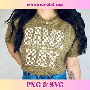 May include: A brown leopard print t-shirt with a white checkered graphic that says "GAME DAY".