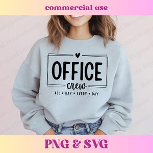 May include: A light blue sweatshirt with the text "OFFICE crew ALL DAY EVERY DAY" in a black rectangle with a small heart above it.