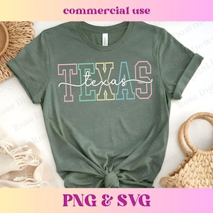 May include: A green t-shirt with the word "TEXAS" in rainbow colors. The word "texas" is written in cursive underneath the word "TEXAS".