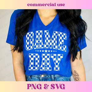 May include: A royal blue t-shirt with a white checkered design that says "GAME DAY" in a vintage style font.