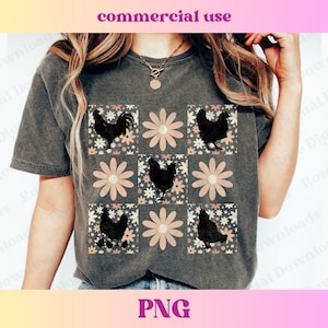 May include: A gray t-shirt with a design of black silhouettes of chickens and flowers in a patchwork pattern.