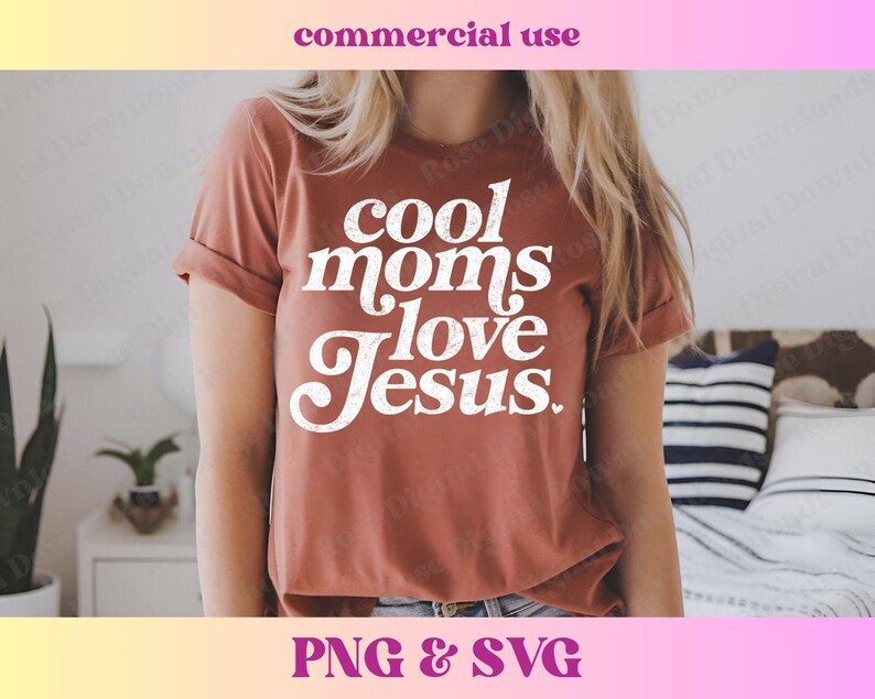 May include: A rust-colored t-shirt with the text "Cool Moms Love Jesus" in white lettering. The shirt has a relaxed fit and a crew neck.