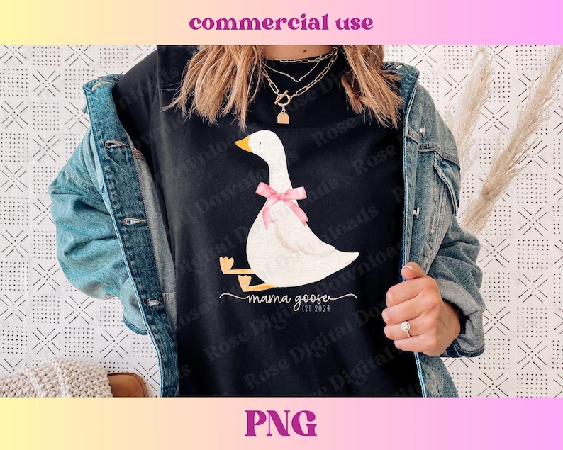 May include: Black t-shirt with a white goose illustration wearing a pink bow. The text "mama goose est 2024" is below the goose. The image also includes the words "commercial use" and "PNG" at the top and bottom.