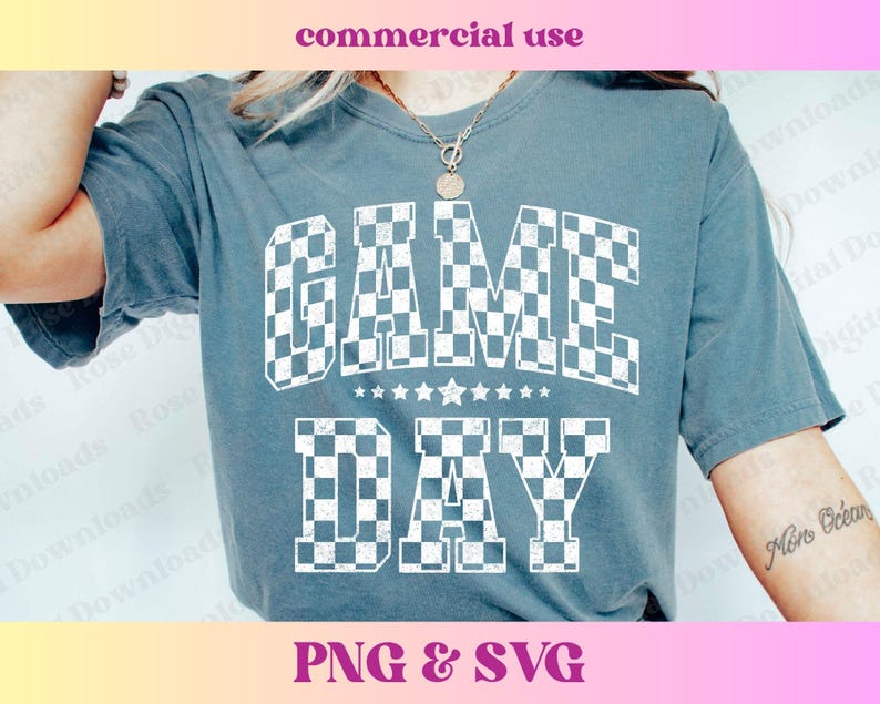 May include: A blue t-shirt with the text "GAME DAY" in white checkered letters. The letters are outlined in black and have a distressed look.