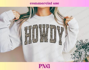 May include: White sweatshirt with the word "HOWDY" printed in a leopard print design.