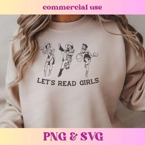 May include: A beige sweatshirt with a graphic of three cowgirls reading books. The text "Let's Read Girls" is printed below the graphic.