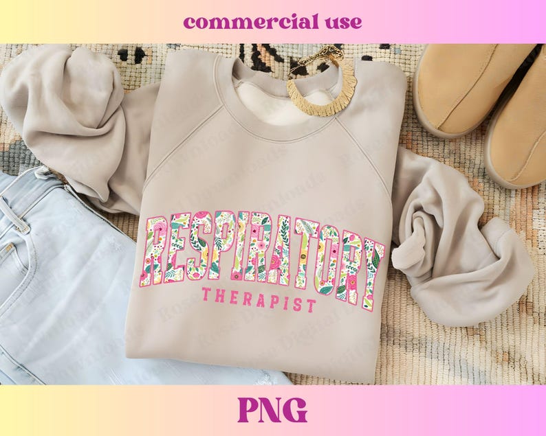 May include: A light gray sweatshirt with the text "RESPIRATORY THERAPIST" in pink letters with a floral pattern. The letters are in a bold, blocky font.