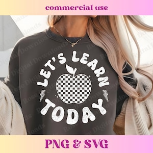 May include: A gray sweatshirt with a white graphic design of an apple with a checkered pattern and the text "Let's Learn Today".