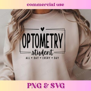 May include: A light beige sweatshirt with the text "OPTOMETRY -student- ALL DAY EVERY DAY" in black lettering. A small heart symbol is above the text.