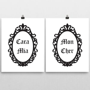 May include: Two black and white printable wall art prints with ornate frames. The text on the prints reads "Cara Mia" and "Mon Cher".