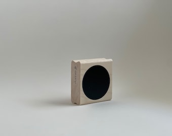 May include: A wooden stamp with a black circle in the center. The stamp is labeled "GALAXY" on the side.